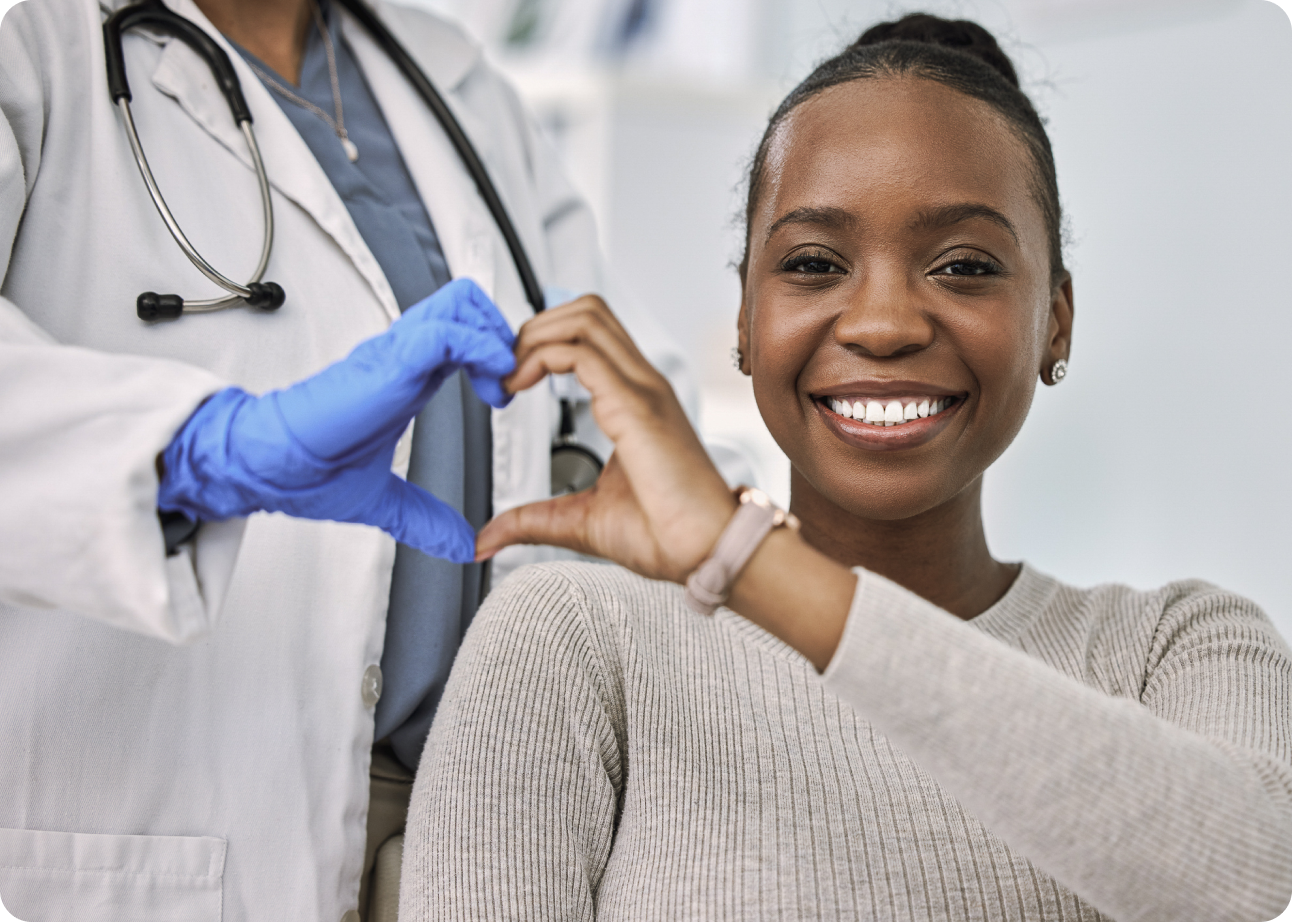 Doctor and patient each holding their hand up, joining them together to create a heart shape