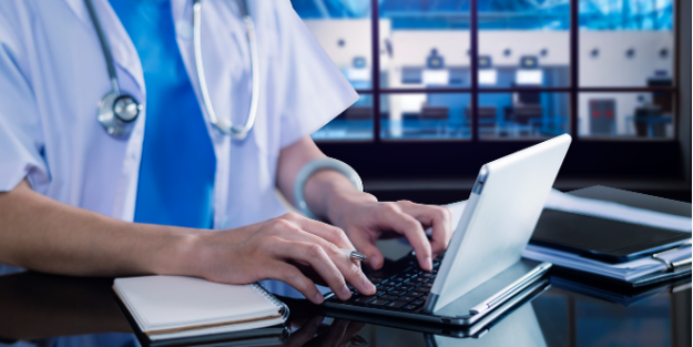 Doctor typing on laptop