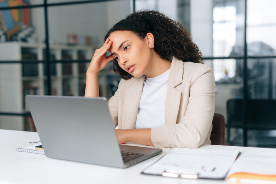 Upset frustrated healthcare worker struggling to stay compliant while sending sensitive faxes without slowing down