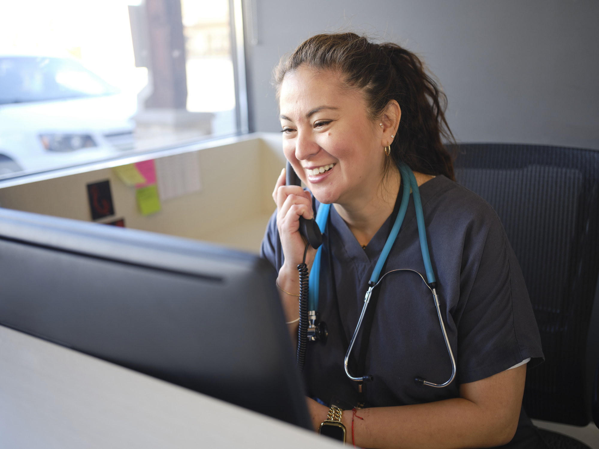A healthcare working at a reception desk in an office
