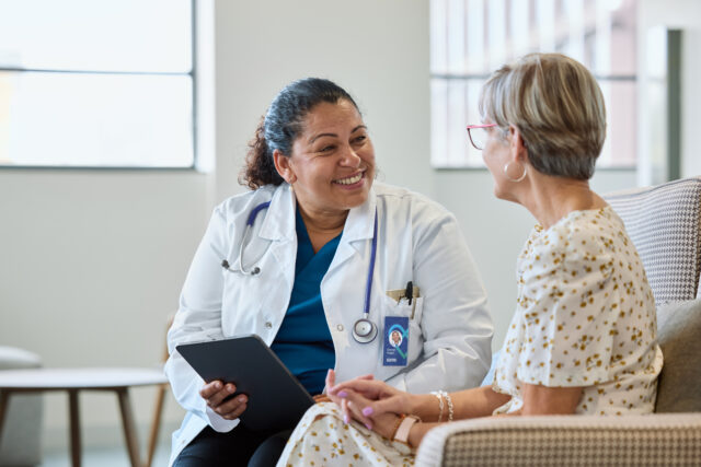 Physician sharing good news with senior woman