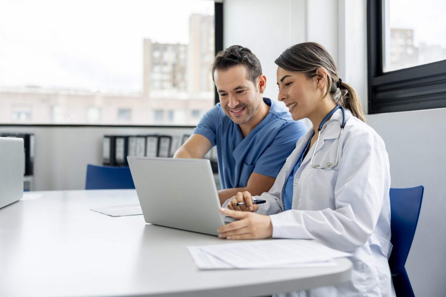 Team of doctors working on a laptop in the meeting room at the hospital