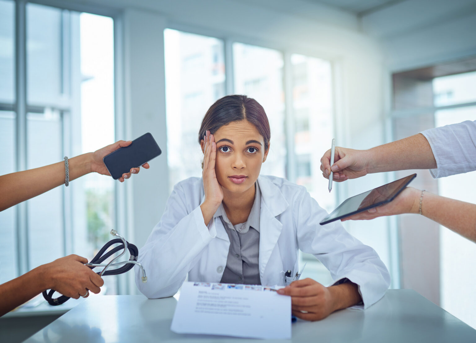 Portrait of a young female doctor looking stressed out in a demanding work environment