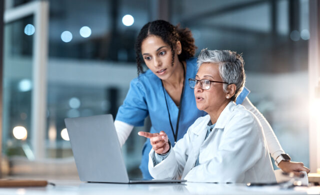 Two medical professionals enjoying HIPAA-compliant cloud fax services