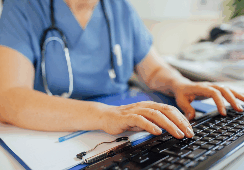 Doctor typing on a keyboard